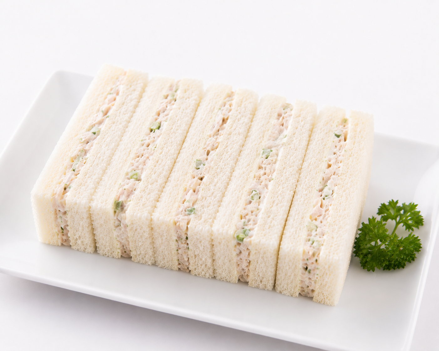 Rolled sandwich with visible layers on a white plate