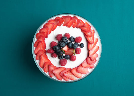 Fruit-topped dessert on a teal background
